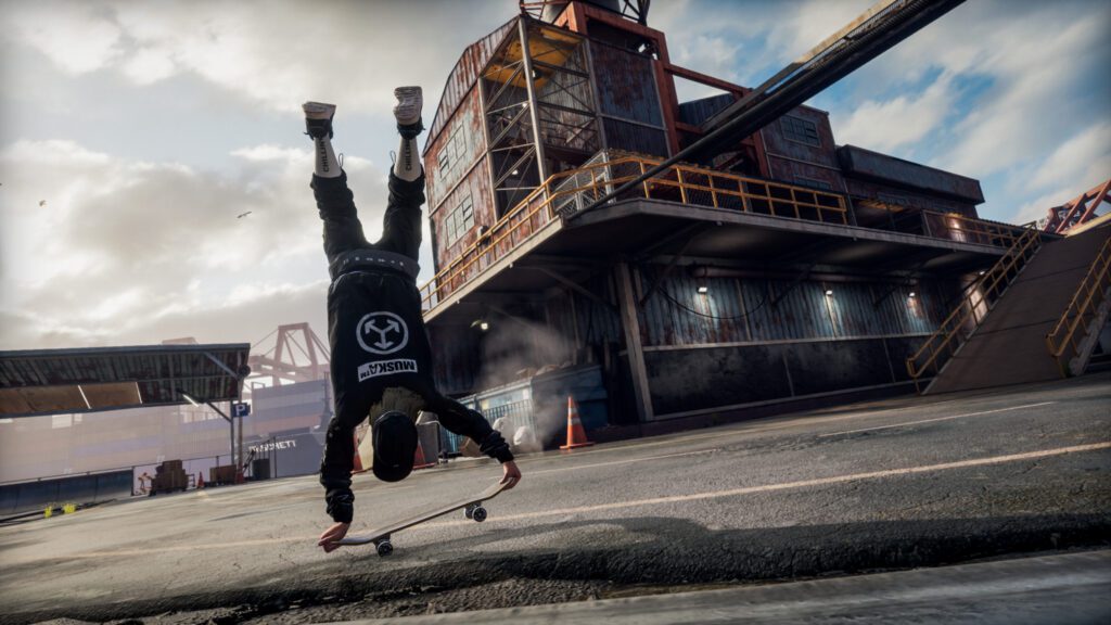 A skateboarder does a hand stand trick