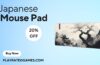 Extended black mouse pad with Japanese Kanagawa wave design and stitched edges on a desk setup