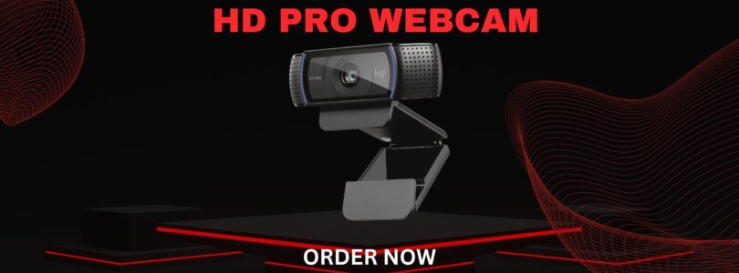 Logitech C920x HD Pro Webcam in black mounted on a monitor, showing its dual microphones and full HD lens.